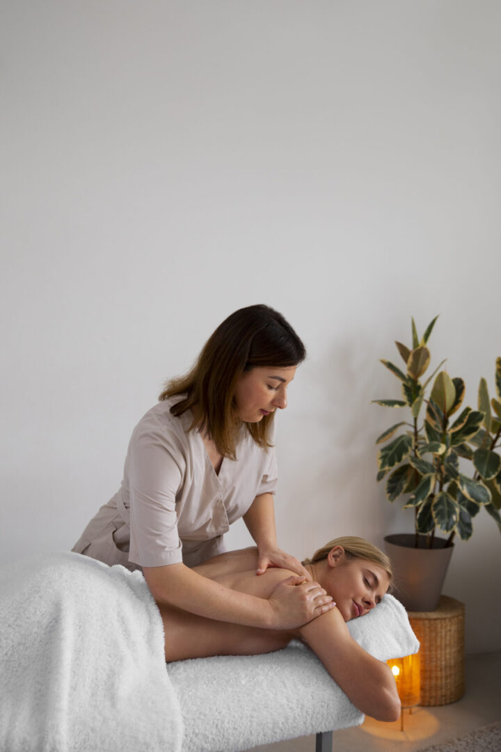 woman-getting-back-massage-from-masseur woman-getting-back-massage-from-masseur